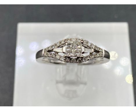 A pretty diamond ring set with princess cut tapered baguette and full cut diamonds 14ct gold size L 2.6 gms