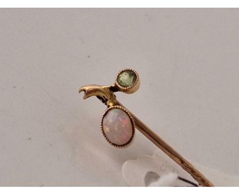 A vintage fiery opal and peridot stick pin with screw top 15ct gold