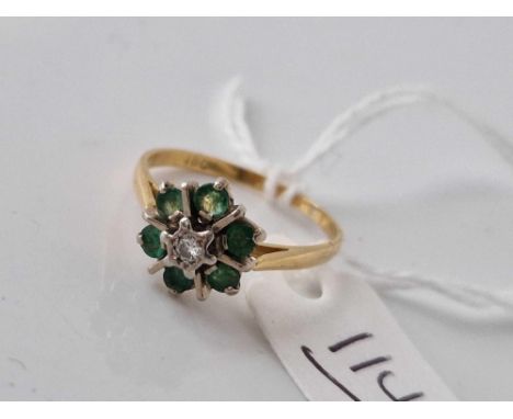 A emerald and diamond cluster ring 18ct gold size O