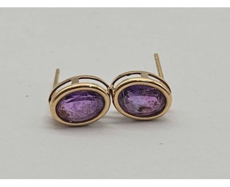 A pair oval amethyst studs 9ct