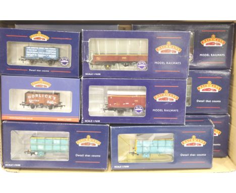 Twelve assorted Bachmann wagons including VBA vans and OCA wagon, some weathered. P&amp;P Group 2 (£18+VAT for the first lot 