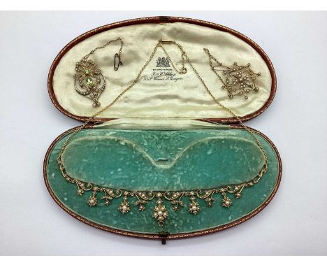 A Decorative Edwardian Pearl Set Necklace, of graduated flowerhead and scroll design (hinged suspension loop behind central f