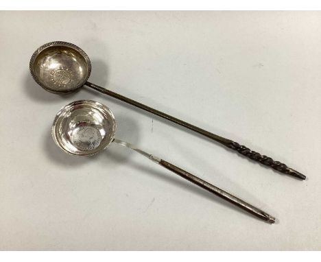 A Georgian Toddy Ladle, the circular bowl with gadrooned edge and inset Spanish Real 1734, twisted handle (overall length 30.