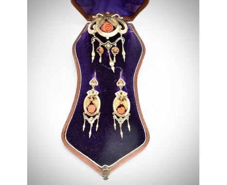 A cased 19th century Victorian earrings and brooch parure.&nbsp; The brooch and earrings having carved coral roses set amongs