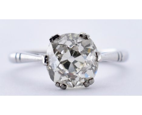 An 18ct white gold and diamond solitaire ring. The ring set with an old European cut diamond in a cathedral setting. Estimate