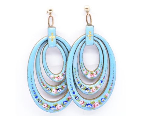 A pair of enamel, gold and yellow metal set drop earrings. The earrings formed oval concentric hoops decorated with enamel fl