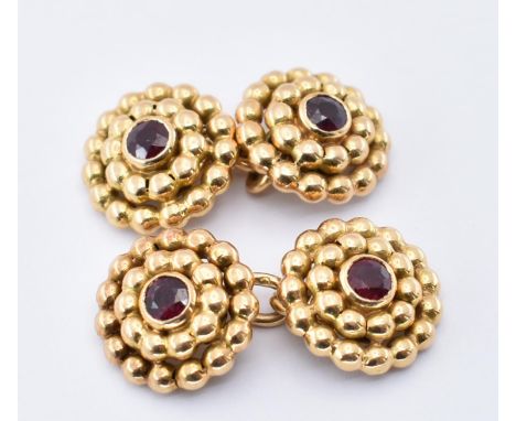 A pair of 18ct gold&nbsp; and&nbsp; ruby Mellerio cufflinks. The cuff links set with a central round cut ruby surrounded by g