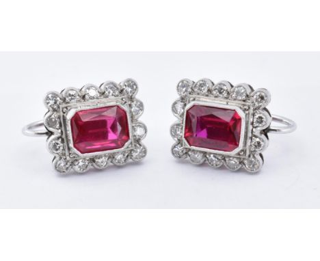 A pair of 18ct white synthetic ruby and diamond cluster earrings. The earrings set with a central octagon cut synthetic ruby 