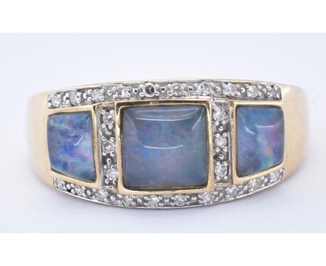 A hallmarked 9ct gold opal and diamond cluster ring. The ring set with three opal cabochons framed by single cut diamonds to 