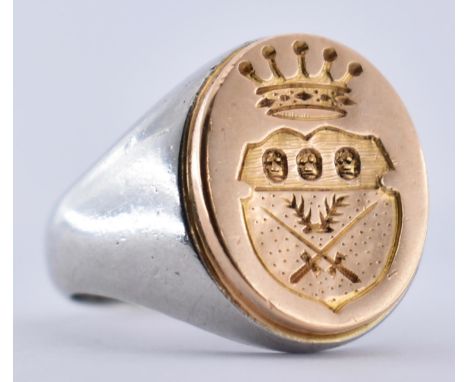 A French platinum and 18ct gold intaglio chevalier signet ring. The ring set with a central intaglio heraldic shield plaque i