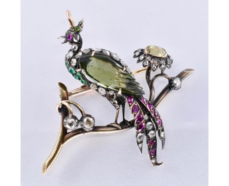 A 19th century bird of paradise figural brooch. The brooch depicting a bird, peacock, bird of paradise perched upon a branch.