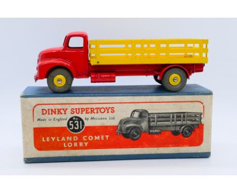 Dinky - A boxed Leyland Comet Lorry in red with yellow wheels and back # 531. The model appears in Very Good condition with o