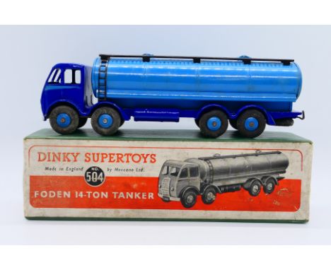 Dinky - A boxed Foden 14-Ton Tanker in dark blue with light blue wheels, side flash and tank body # 504. The models appears i