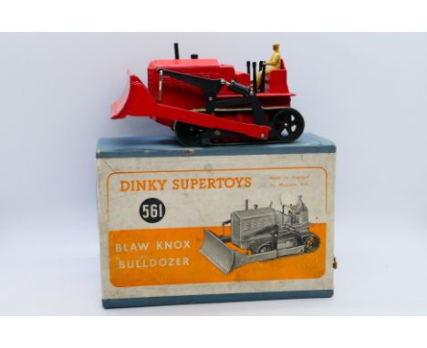 Dinky - A boxed Blaw Knox Bulldozer in red with green tracks # 561. The model appears in Very Good condition with only light 