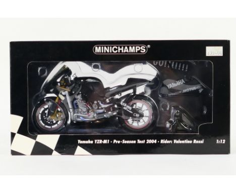 Minichamps - A boxed 1:12 scale Yamaha YZR-M1. Pre-Season Test 2004 Rider: Valentino Rossi. The model appears Mint in a Very 