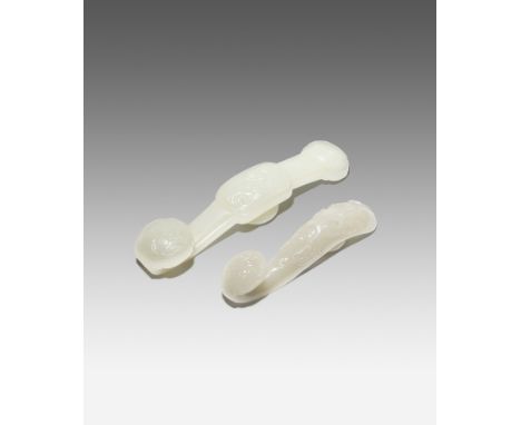 TWO CHINESE WHITE JADE RUYI SCEPTRE-SHAPED BELTHOOKS QING DYNASTY The larger belthook carved with the sanduo, with sprays of 