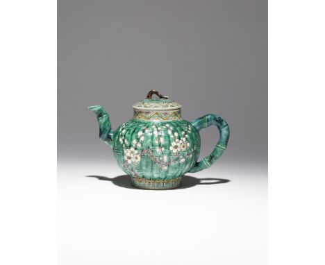 A CHINESE FAMILLE VERTE MOULDED 'PRUNUS' TEAPOT AND COVER KANGXI 1662-1722 Decorated with two large sprays of prunus against 