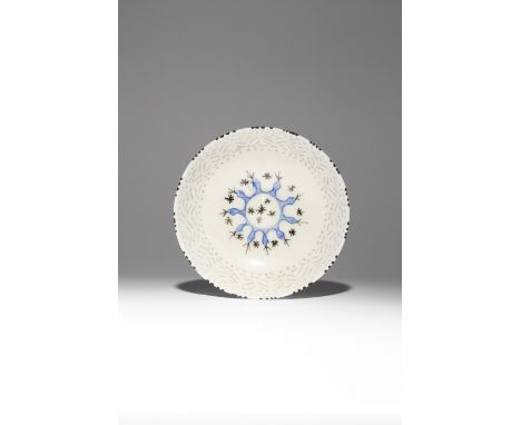 A SAFAVID GOMBROON WARE BOWL 17TH/18TH CENTURY The well with a circular raised boss painted with black stars, the medallion s