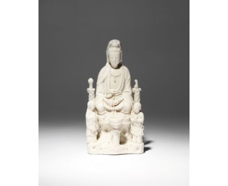 A CHINESE BLANC DE CHINE FIGURE OF GUANYIN 17TH/EARLY 18TH CENTURY The goddess sits in dhyanasana on a rocky pedestal, with h