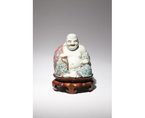 A LARGE CHINESE FAMILLE ROSE FIGURE OF BUDAI HE SHANG EARLY 20TH CENTURY He sits in a relaxed pose with a cheerful expression
