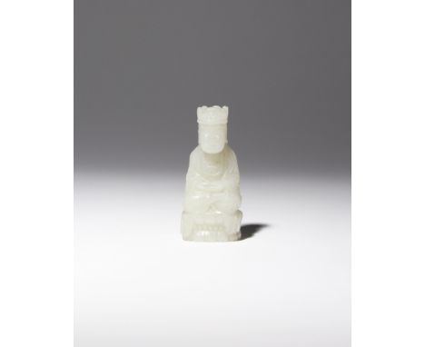 A CHINESE PALE CELADON JADE CARVING OF GUANYIN QING DYNASTY Depicted seated in dhyanasana upon a beaded double lotus throne, 