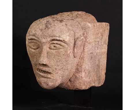 A Celtic sandstone head with bared teeth,200-300 AD, English, the oval eyes with 'drilled' pupils,head 18.5cm high22.5cm deep