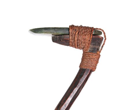 A Maori 'toki',19th century, the adzed curved wooden shaft supporting a greenstone adze blade bound with flax,51cm long, toge