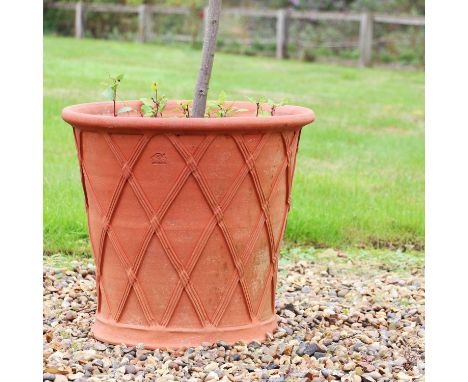 A Whichford Pottery terracotta planter,with basket weave sides, impressed mark, now planted with a bay tree,55cm diameter51cm