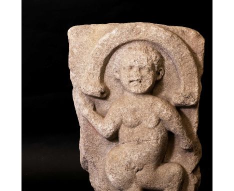 A Celtic limestone slab,1st-2nd century AD, Irish, carved with a dancing deity and illegibly inscribed to the arch above, pro