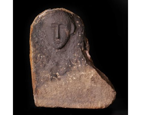 A carved limestone Celtic votive head,1st century BC-1st century AD, of a male warrior, from a shrine, mounted on a modern di