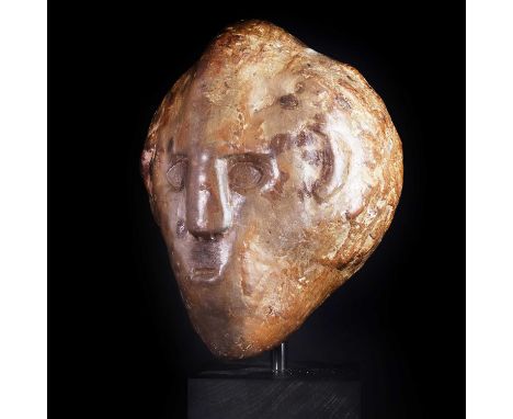 A Celtic flint head of a young man,the eyes possibly re-carved, mounted on a modern ebonised plinth,head 19cm highProvenance: