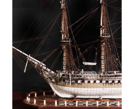 A fine prisoner-of-war ship model,c.1820, French, a forty-eight gun frigate of the Royal Navy, mounted on an oval, galleried,