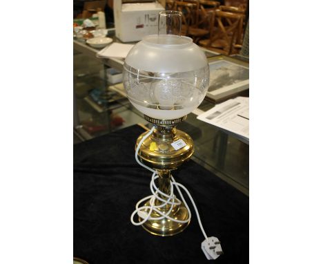 A CONVERTED BRASS OIL LAMP AND SHADE