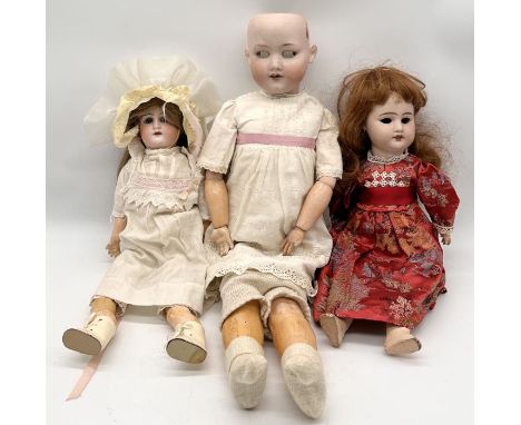 Three antique bisque headed dolls one marked for Armand Marseille 