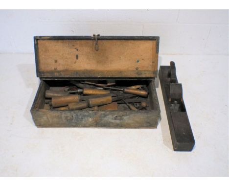 A vintage wooden toolbox containing various tools including wood planes, chisels etc - some marked 'SCARRATT'.
