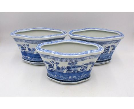 Three Chinese blue and white ceramic plant pots.