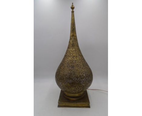 An eastern filigree brass lamp.