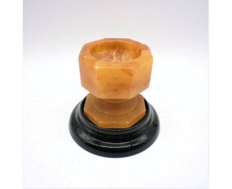 An alabaster font, on ceramic stand.