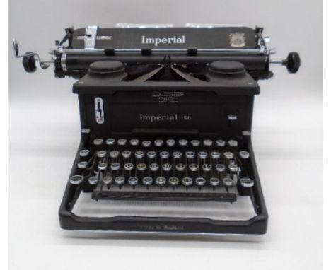 A vintage Imperial 58 typewriter with two spare ribbons.