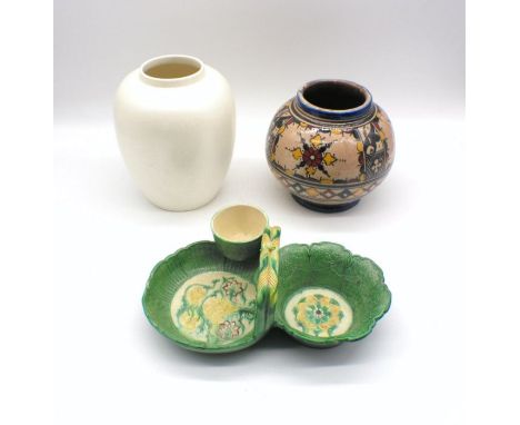 A continental ceramic strawberry dish with floral design, along with an Islamic vase and a Poole vase.