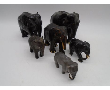 A collection of vintage elephants including ebony and ceramic