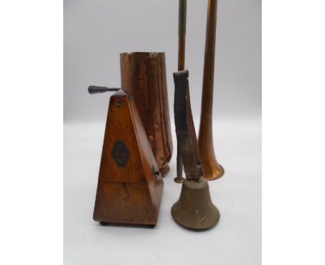 A collection of copper items including a bell, a hunting horn etc plus a metronome. 