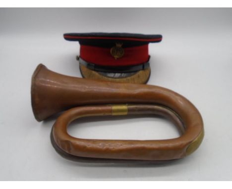 A military cap by Hebert Johnson along with a brass and copper Besson &amp; Co. bugle