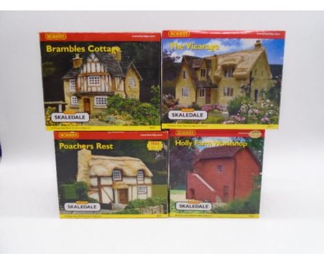 A collection of four boxed Hornby Skaledale OO gauge scale model buildings including Bramble Cottage (R8506), The Vicarage (R