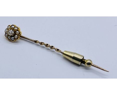 An unmarked gold (tested 9ct) tie pin set with seed pearls and a mine cut diamond- diamond measures approximately 3mm x 4mm