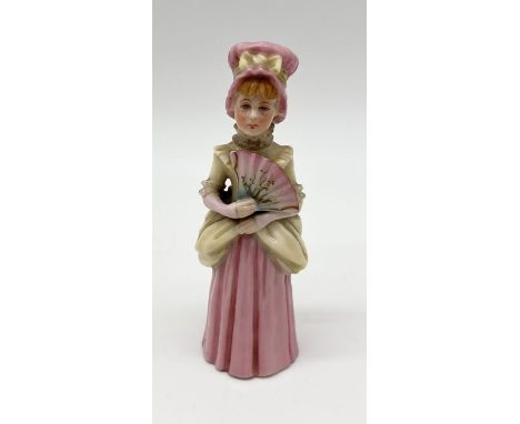 A Royal Worcester candle snuffer 'Town Girl', modelled as a young girl in pastel colouring with gilt highlights, she wears a 