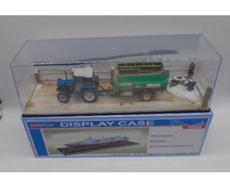 A cased diorama of a Ford Powerstar SL 6640 tractor with Keenan Klassik 140 in Master Tools display case