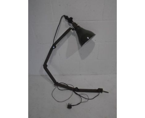 A vintage industrial angle-poise machinist lamp with green enamelled shade