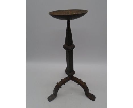 A wrought iron candlestick on tripod legs, height 45cm