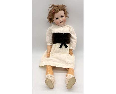 A Max Handwerk Bebe Elite bisque headed fully jointed doll with open mouth and sleeping eyes numbered 286 - height 53cm